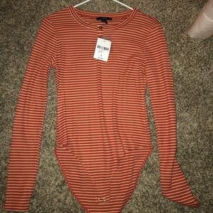 burnt orange and white long sleeve body suit